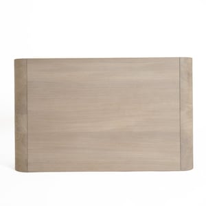 May include: A light brown wooden headboard with a curved top and a smooth, slightly textured surface.