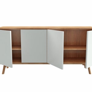 May include: A wooden cabinet with three white doors and two shelves. The cabinet has rounded edges and sits on four wooden legs.