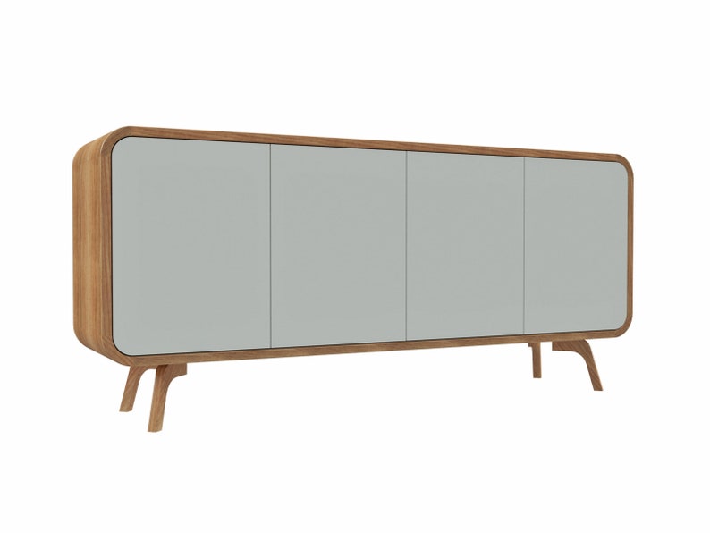 May include: A light gray cabinet with three doors and rounded edges. The cabinet has a wood frame and sits on four wooden legs.