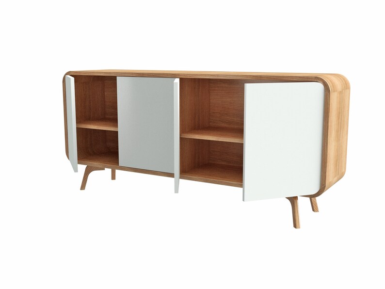May include: A wooden sideboard with white doors and two shelves. The sideboard has rounded edges and curved legs.