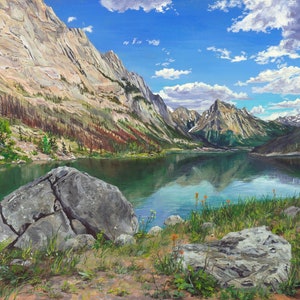 May include: An oil painting depicts a serene mountain lake scene. Towering, rugged mountains surround the turquoise water, reflecting the blue sky dotted with fluffy white clouds. Foreground features rocks and green grass.