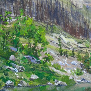 May include: An acrylic painting of a mountain landscape. The scene depicts a rocky hillside with patches of green vegetation and small trees. A dark forest is visible on the right side of the painting. The bottom of the painting shows a body of water.
