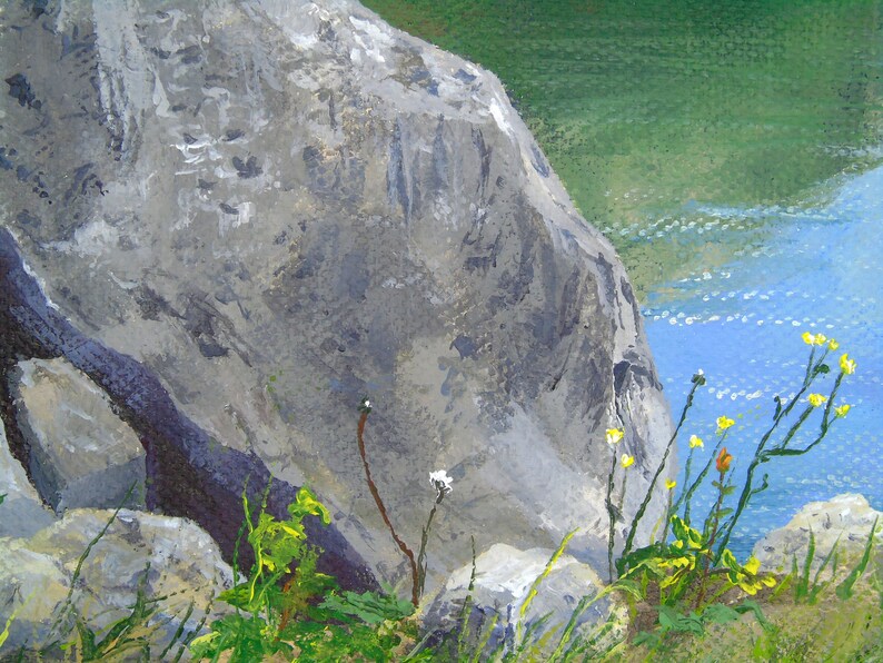 May include: An oil painting depicts a rocky landscape with a body of water. A large gray rock formation dominates the left side, with hints of green vegetation and yellow wildflowers in the foreground. The water is blue.