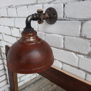 Rusty hanging wall lamp.Industrial wall light.