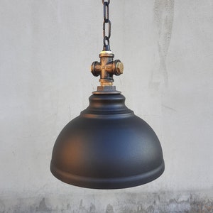 Suspended industrial black lampshade. Rustic kitchen chandelier for a country house.