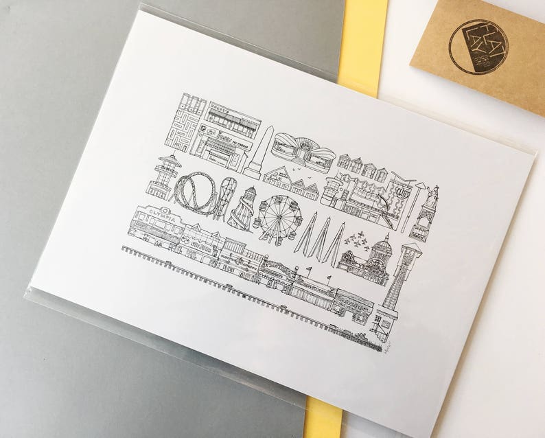 May include: Black and white line drawing illustration of a seaside amusement park with a Ferris wheel, roller coaster, and other attractions. The illustration is on a white background.