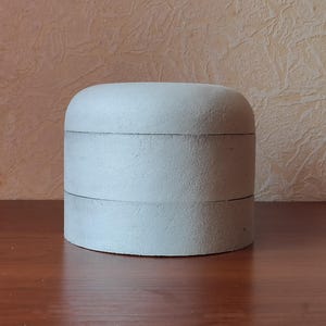 Hat block of polystyrene, small rounding top. Height 8-13 cm.