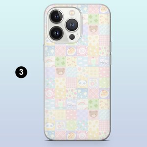 May include: A clear phone case featuring a patchwork design with pastel squares. Each square has a different pattern, including teddy bears, rainbows, and desserts. The case has a clear border and a camera cutout.
