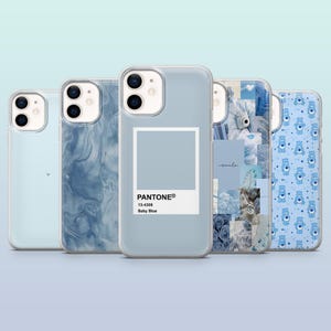 May include: Five different phone cases with blue designs. The cases are all clear and show the phone's camera lenses. One case has a blue marble design, one has a blue color swatch with the Pantone color name "Baby Blue", one has a collage of blue images, one has a solid light blue color, and one has a pattern of blue teddy bears.