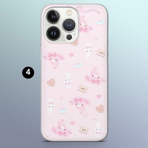 May include: Pink phone case with a repeating pattern of cartoon bunnies, hearts, and cookies. The case has a clear border and a camera cutout. The number "4" is in a black circle in the upper left corner.