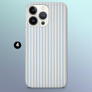 May include: A clear phone case with a white and light blue striped pattern. The case is designed for a phone with a triple camera system.
