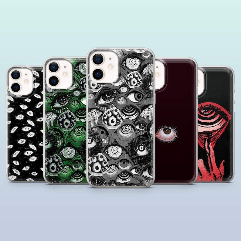Op de afbeelding: Een verzameling van vijf telefoonhoesjes met unieke oogthema-ontwerpen. De hoesjes hebben verschillende kleuren, waaronder zwart, wit, groen, grijs en rood. Elk hoesje toont een andere artistieke interpretatie van ogen.