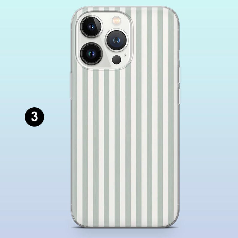 May include: A clear phone case with a white and light gray striped pattern. The case is designed for a smartphone with a triple camera system.