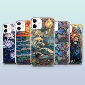 May include: Five different iPhone cases with stained glass designs. The designs include a sunset over the ocean, a lion, a sun and clouds over the ocean, a lotus flower, and a mosaic of gemstones.
