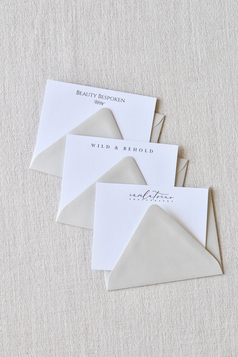 May include: Three white envelopes with different text on each. The top envelope says "Beauty Bespoken" with a small branch design. The middle envelope says "Wild & Behold". The bottom envelope says "inlatrevo photography".