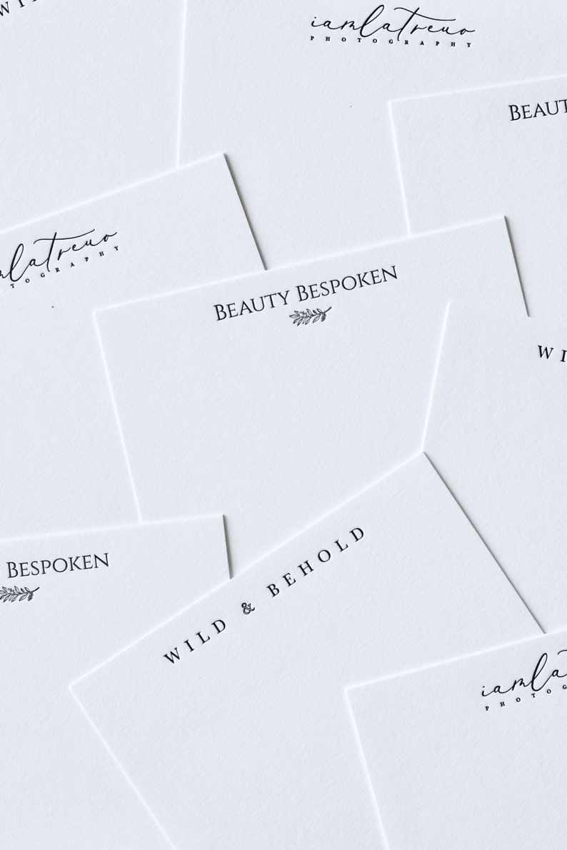 May include: A collection of white cards with black text. The cards feature the text "Beauty Bespoken", "Wild & Behold", and "Bespoken" with a small leaf design. The cards also feature the text "iamlatreuo Photography".