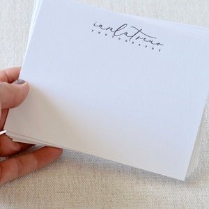May include: A stack of white note cards with a black and white logo that says "anlatreno photography" printed on the top card.