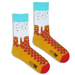 May include: A pair of yellow and red socks with a white ice cream cone design and colourful sprinkles. The socks have the text "Koala Rulez" on the bottom.