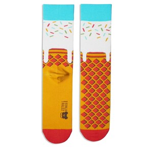 May include: A pair of yellow and red socks with a white ice cream cone design. The ice cream is dripping down the cone and has colourful sprinkles on top. The socks have the text "Koala Rulez" on the side.
