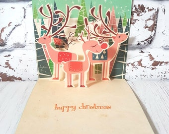 Handgemaakte pop-up rendierkerstkaart: retro kerstontwerp