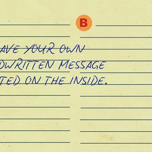 May include: A lined sheet of paper with the letters A and B circled in orange. The text "HAVE YOUR OWN HANDWRITTEN MESSAGE PRINTED ON THE INSIDE." is written in blue ink.