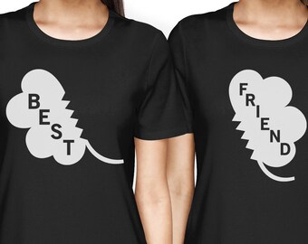 Puede incluir: Dos camisetas negras con un diseño de trébol blanco. Una camiseta dice "BEST" y la otra dice "FRIEND".