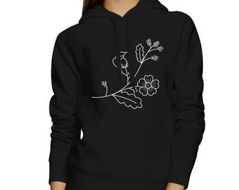 May include: Black hooded sweatshirt with a white floral design on the front. The design features a stylized branch with leaves and flowers.