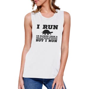 May include: White sleeveless shirt with black text that reads "I RUN I'M SLOWER THAN A HERD OF TURTLES STAMPEDING THROUGH PEANUT BUTTER BUT I RUN" and a black silhouette of a turtle.
