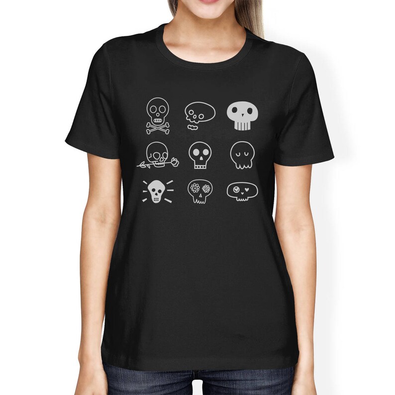 May include: Black t-shirt with a white design of various skull illustrations. The skulls have different features, including flowers, eyes, and a lightbulb.