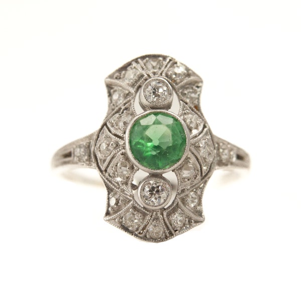 Art deco style emerald and diamond engagement ring
