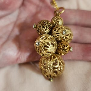 Vintage Swarovski gold-plated filigree balls pendent.