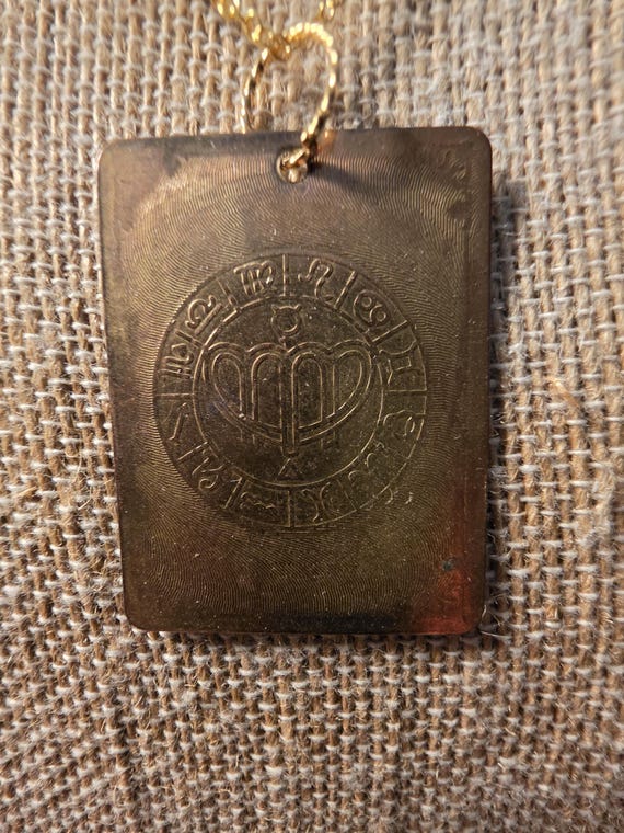 AURUM tablet with alchemical symbols pendent.