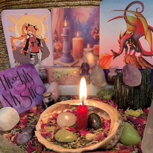 May include: A collection of spiritual items including three illustrated cards, a burning red candle in an abalone shell, various polished gemstones, dried flower petals, and a purple square card with the text Highly Mystic printed in black.
