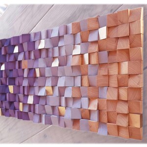 a wooden texture composed of small square tiles in various shades of purple and orange, arranged in a grid-like pattern.