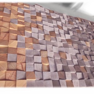 a close-up view of a textured surface composed of numerous small wooden blocks arranged in a repeating pattern. The blocks vary in size and shape, creating a visually interesting and intricate design.
