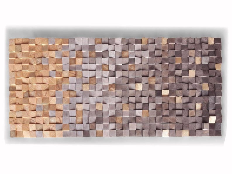 The image is a large, rectangular, and textured surface composed of numerous small, square-shaped wooden blocks in various shades of brown and gray. The blocks are arranged in a grid-like pattern, creating a visually striking and intricate design.