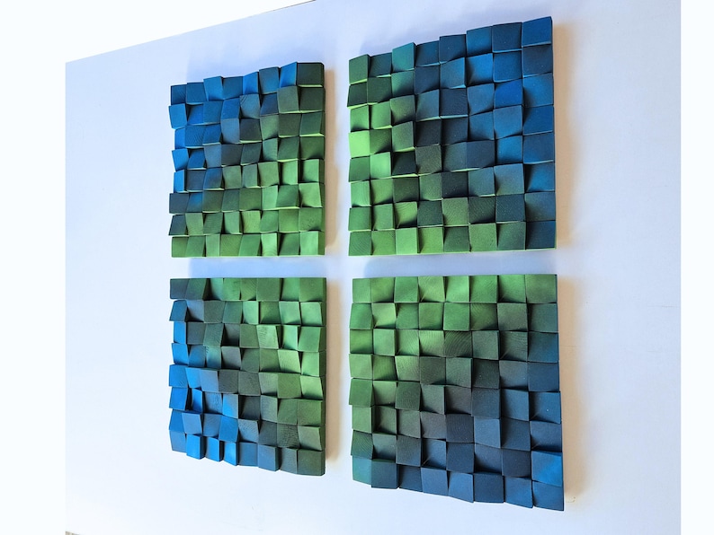 four square-shaped sculptures made of small, colorful blocks arranged in a grid-like pattern on a white background.