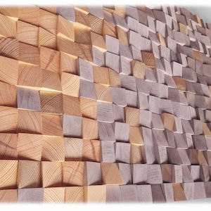 The image is a close-up of a wall made up of numerous wooden planks arranged in a textured, mosaic-like pattern. The planks vary in size and shape, creating a visually interesting and intricate design.