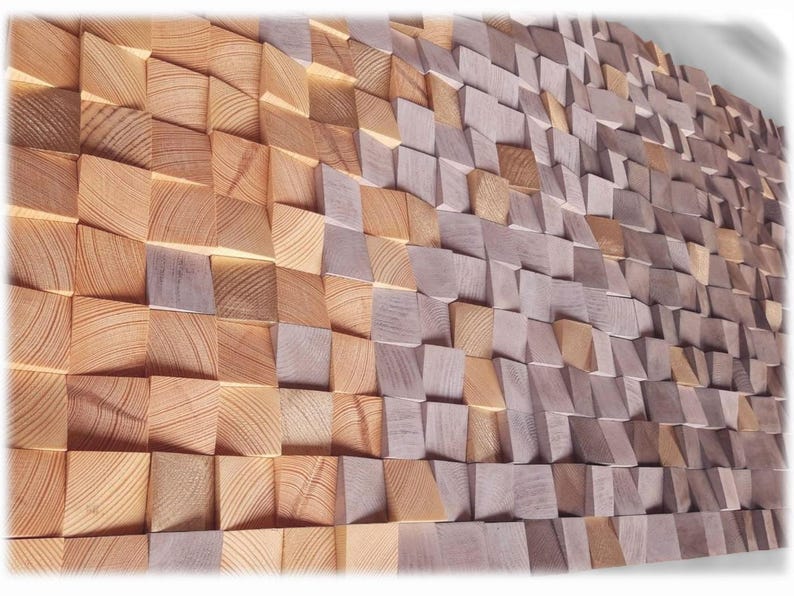 The image is a close-up of a wall made up of numerous wooden planks arranged in a textured, mosaic-like pattern. The planks vary in size and shape, creating a visually interesting and intricate design.