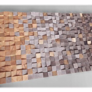 a large, textured surface composed of numerous small, square-shaped wooden blocks in various shades of brown and gray. The blocks are arranged in a pattern that creates a visually striking and intricate design.