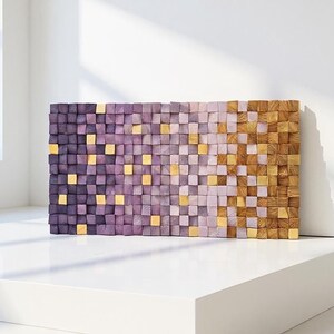 a rectangular wooden wall art piece composed of small square tiles in various shades of purple and brown, arranged in a grid-like pattern.