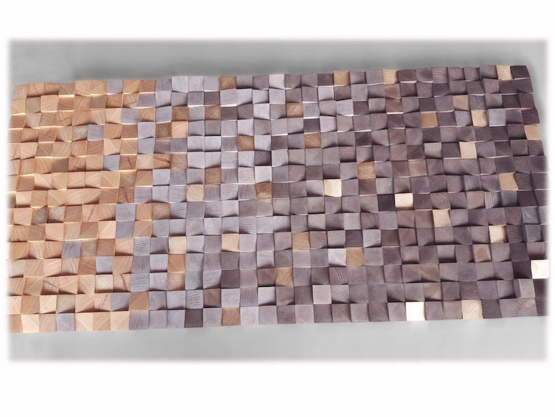 a large, rectangular arrangement of small, square-shaped wooden blocks in various shades of brown and gray, creating a textured and visually interesting surface.
