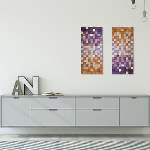 a minimalist interior design with a gray cabinet, a large abstract art piece, and a letter 'N' on the wall.