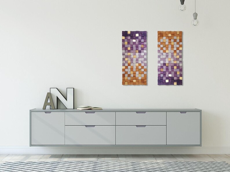 a minimalist interior design with a gray cabinet, a large abstract art piece, and a letter 'N' on the wall.