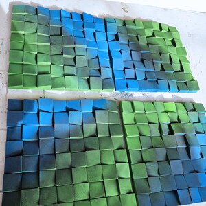 two large, colorful, and textured collages composed of numerous small, square-shaped blocks in various shades of green and blue.