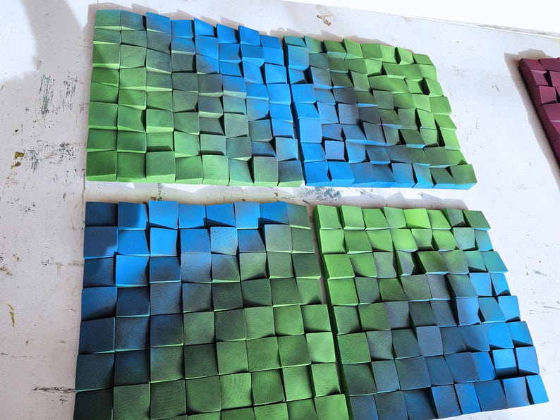 two large, colorful, and textured collages composed of numerous small, square-shaped blocks in various shades of green and blue.