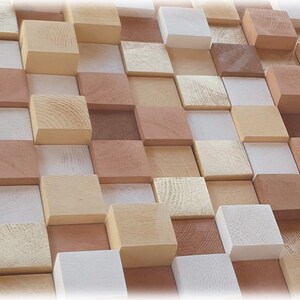 May include: A wall covered in a mosaic of small, square wooden blocks in various shades of brown, beige, and white. The blocks are arranged in a staggered pattern, creating a textured and visually interesting surface.