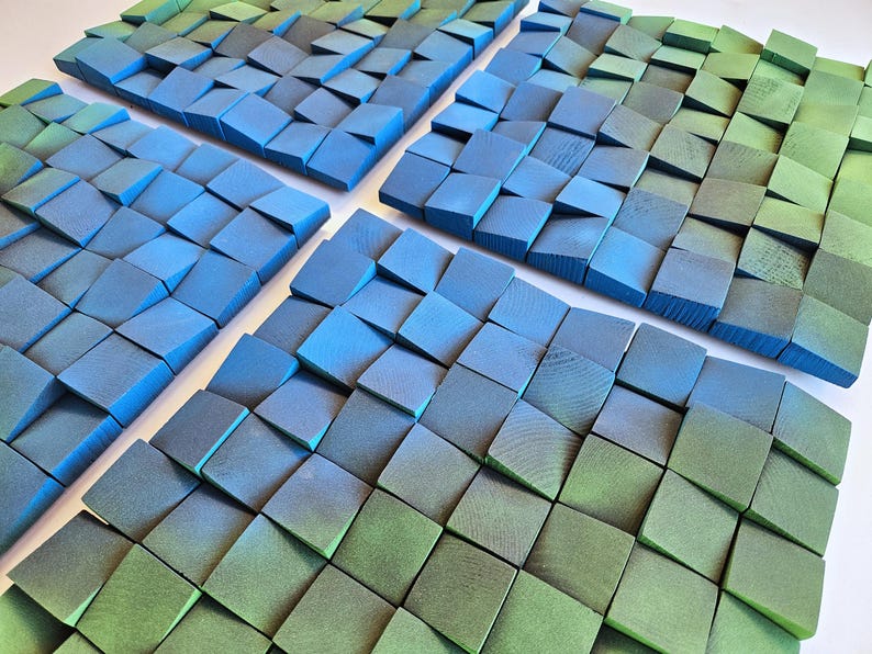 a close-up view of a collection of small, square-shaped objects in various shades of blue and green, arranged in a grid-like pattern.