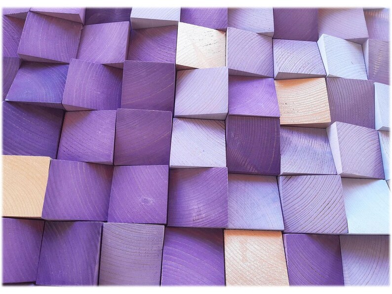 The image is a close-up of a collection of wooden blocks in various shades of purple and beige, arranged in a grid-like pattern.