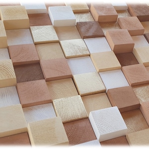 May include: A wall art piece made of various sized wooden blocks in shades of brown, beige, and white. The blocks are arranged in a staggered pattern, creating a textured and visually appealing design.